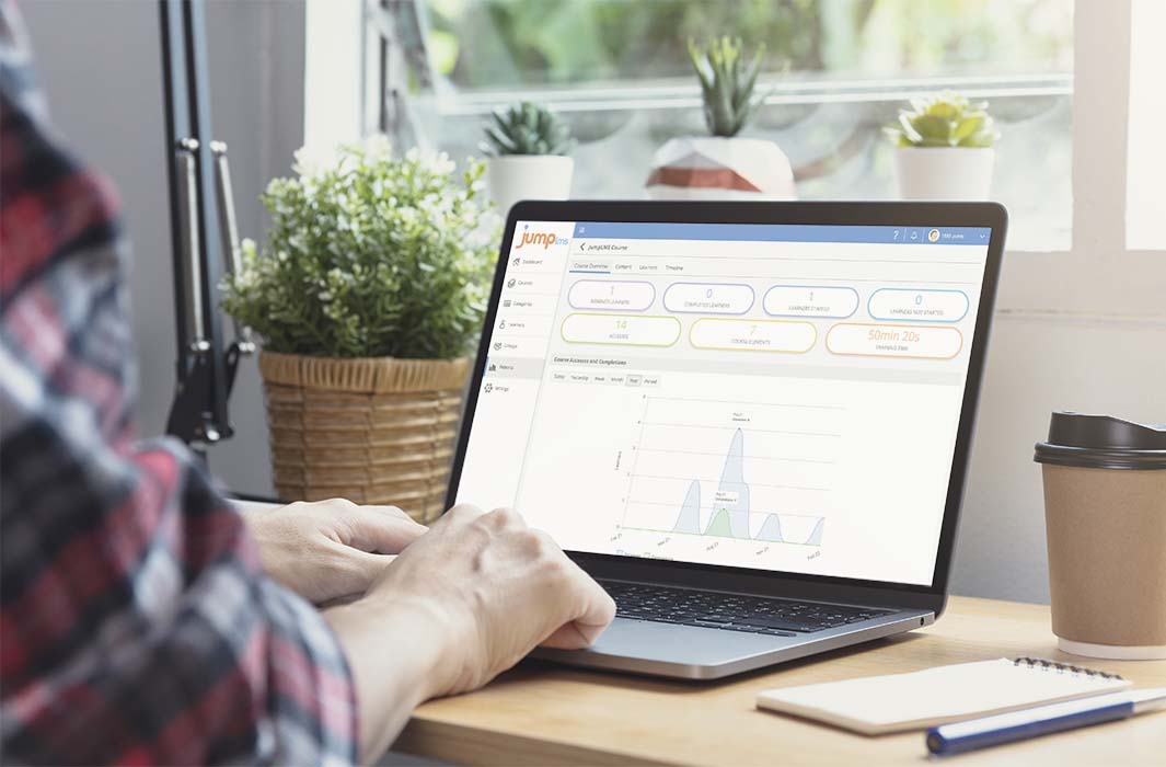 Man working on a laptop examining report